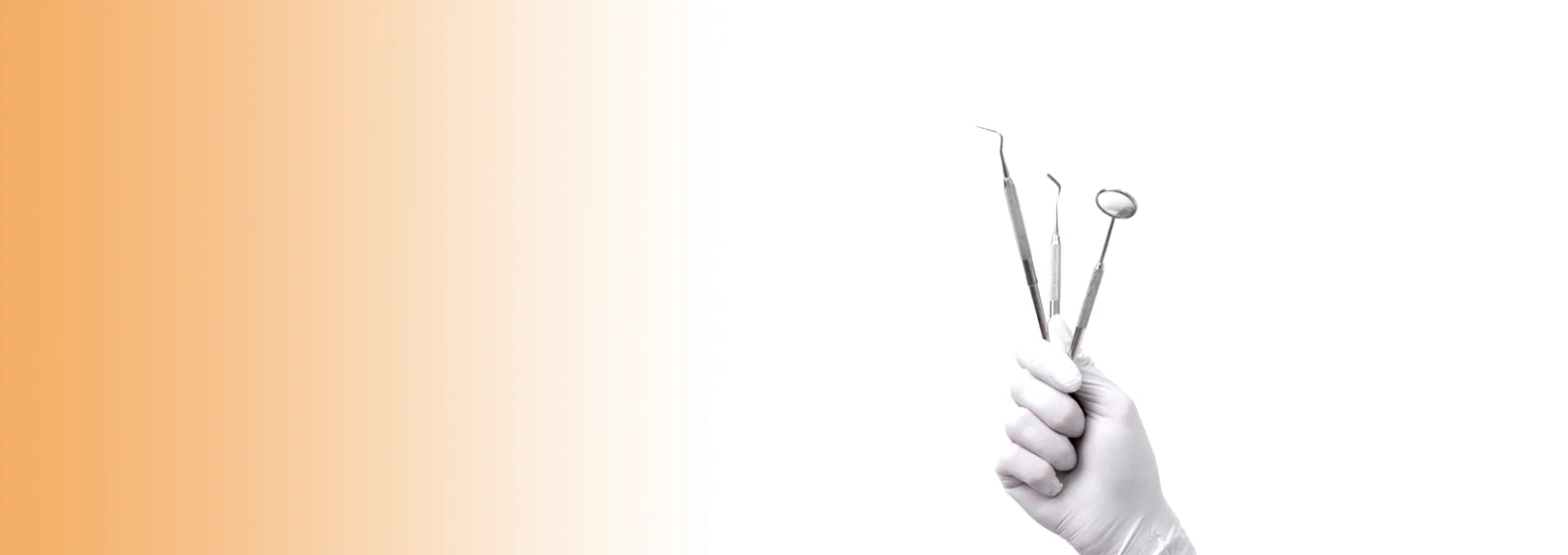 Gloved hand holding dental tools, including a mirror and probes, against a white background with an orange gradient on the left.