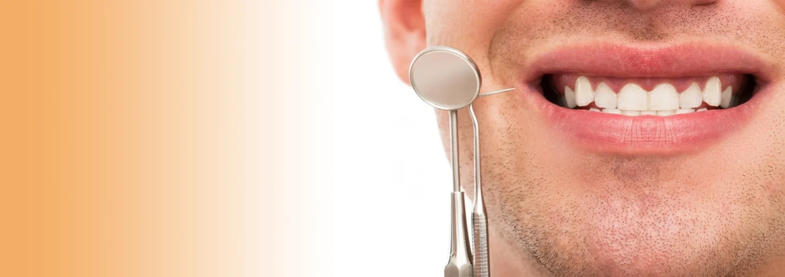 Close-up of a smiling man with dental tools near his teeth, set against an orange gradient background.